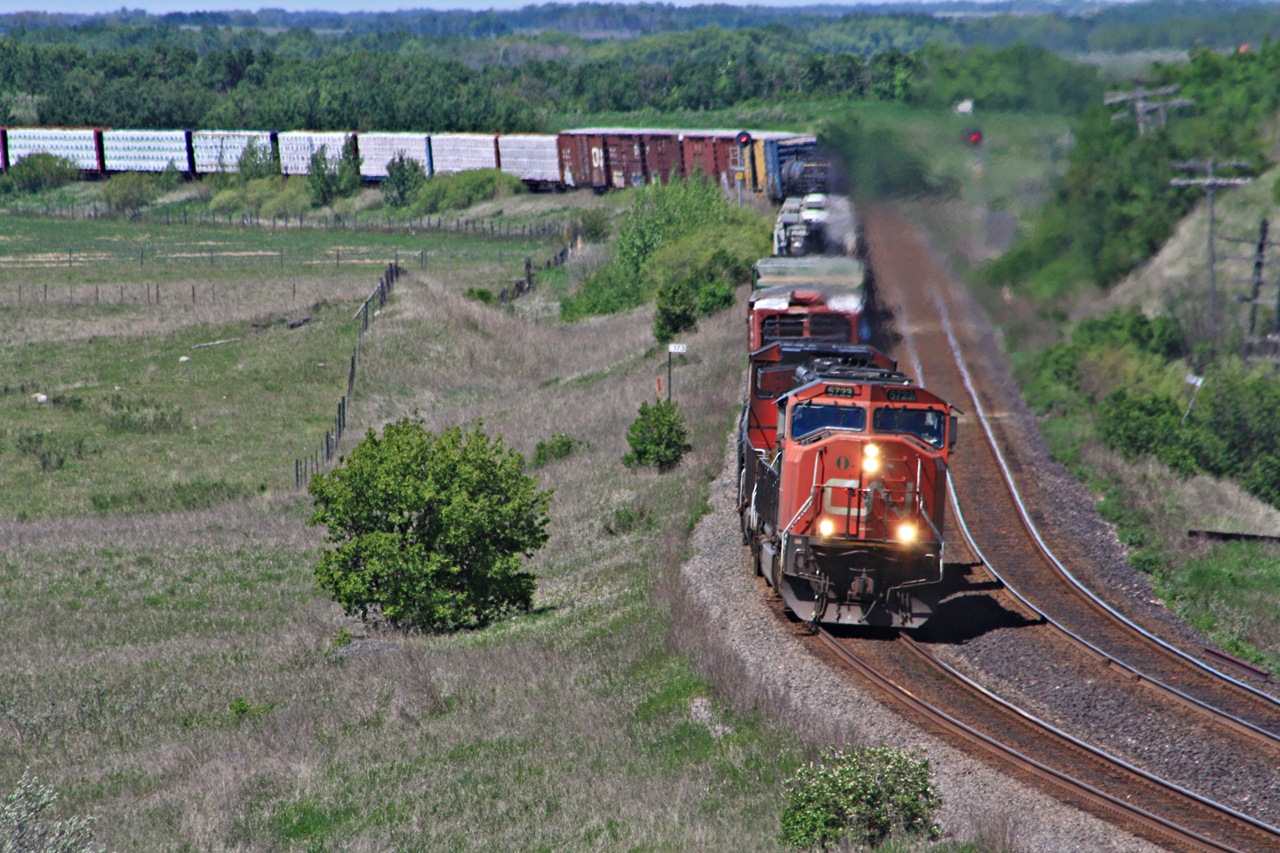 CN 312 heads east with 5723 at the helm as they snake through the double track section at Arrow lake Manitoba. They just passed by train 115 and are slowing for a meet with 111 at the east end of the double track.