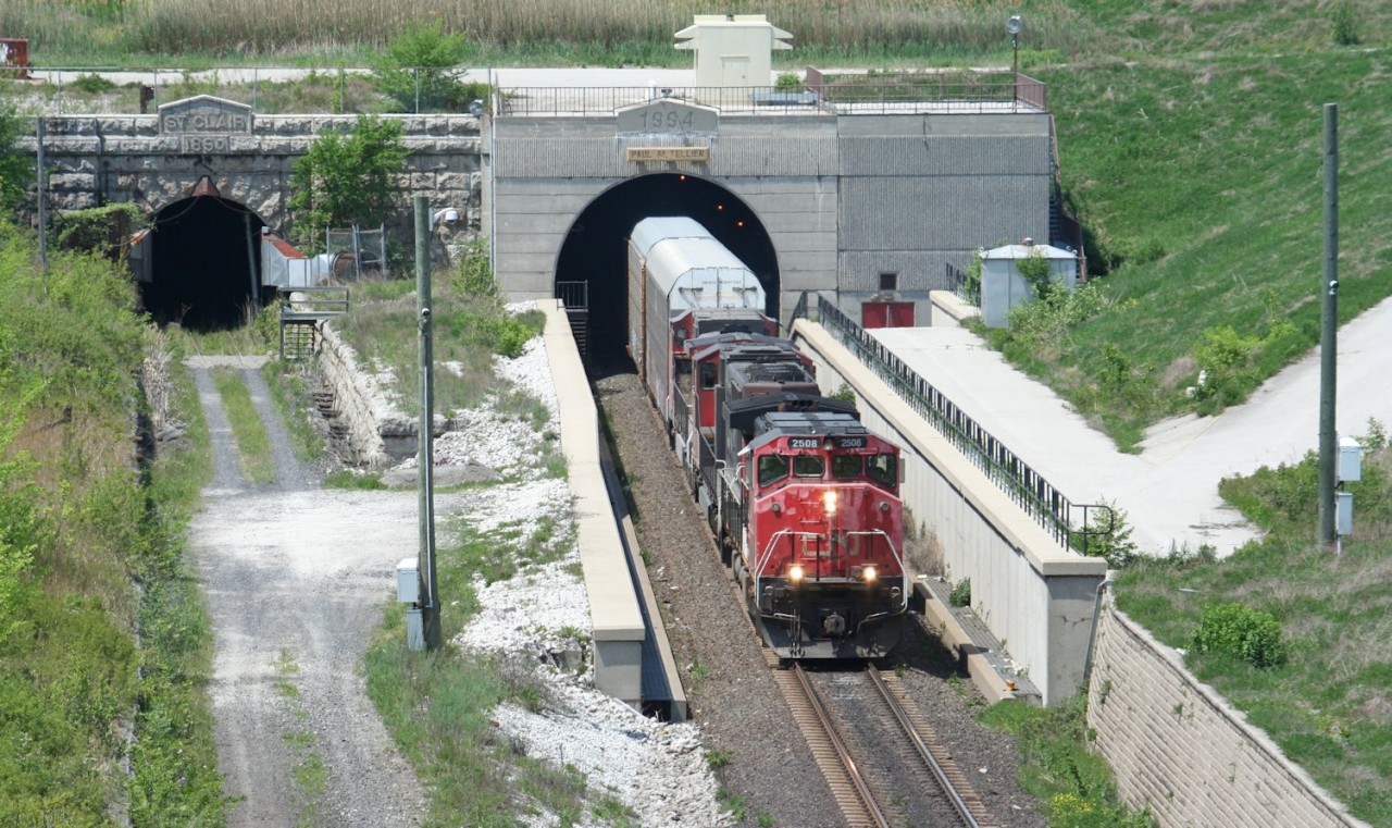 CN 382 burst forth into daylight on the Canadian side of the Paul M. Tellier international railway tunnel beneath the St. Clair River. The original bore of the originally name St. Clair Tunnel stands quiet, having seen its last train 18 years ago.