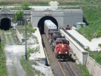 CN 382 bursts forth into daylight on the Canadian side of the Paul M. Tellier international railway tunnel beneath the St. Clair River. The original bore of the originally named St. Clair Tunnel stands quiet, having seen its last train 18 years ago.