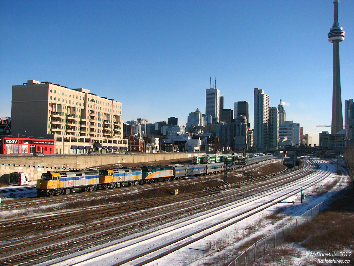 In what was always the pinnacle of a morning at Bathurst Street, VIA #1 the "Canadian" departs Toronto for its cross-country trip to Vancouver, just after 9am. This was no normal morning however, it marked the first time a rebuilt F40PH made the transcontinental trip: 6400, the first rebuilt unit out of CAD Rail in Lachine QC, trails on its way to Vancouver for employee familiarization & training. Alas, mornings at Bathurst Stree aren't the same anymore: the Canadian now departs Toronto under darkness, 6400 was wrecked in a level crossing accident a year or two later, and condos have sprung up, obscuring the line of sight. Time marches on.