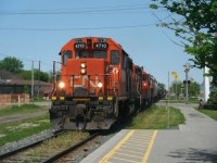 CN 439 led by CN 4710, CN 4136 and CN 4135 as it starts building up speed before leaving town.