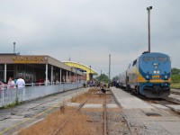 VIA 907 unloads lots of people on Sunday Afternoon at VIA Walkerville Station, in Windsor, Ontario.  Some Afternoon Showers made this afternoon overcast. The new VIA Railstation is in the background will be open later this year.