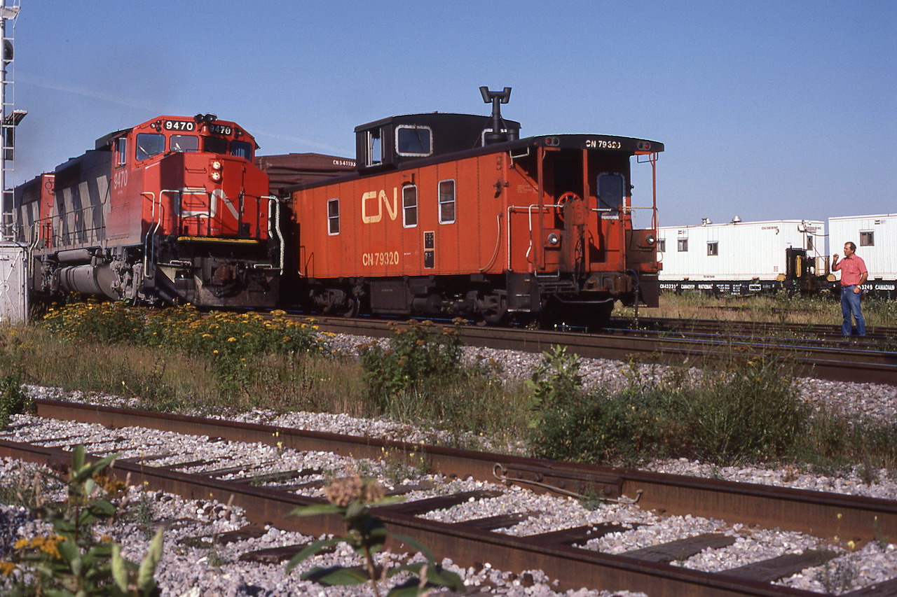 CN 207 proceeds slowly as the 344,s rear brakie watches.