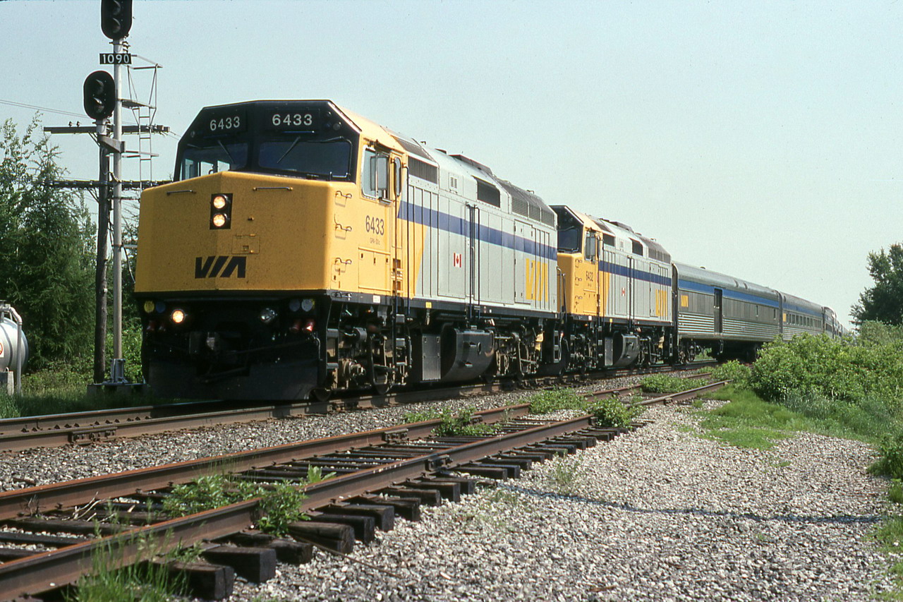 VIA 15 with 6433 and 32 getting back on the main after a meet 10 miles west of Drummondville.