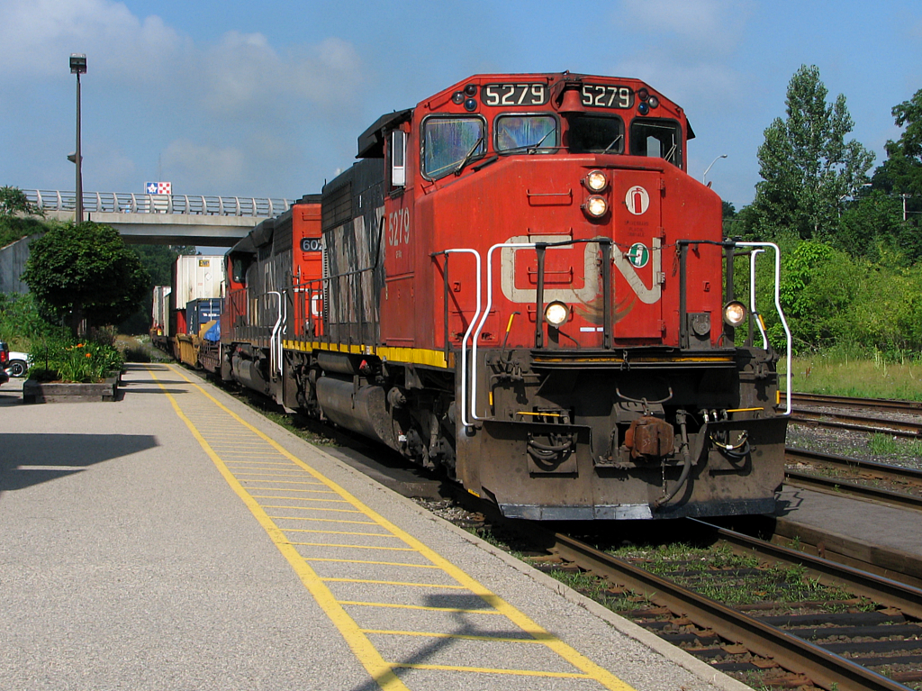 A pair of SD40's lead 148 past the Woodstock VIA station.