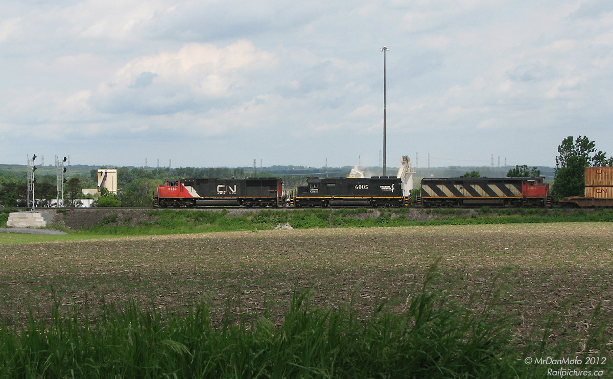 About to knock down the signals at Pickering Junction, CN 5683, IC 6005 and CN 2404 power intermodal #103 through the country-esque parts of Durham Region. The two photographers would then head west, and just miss shooting it at the crossing outside Georges' Trains in Markham.