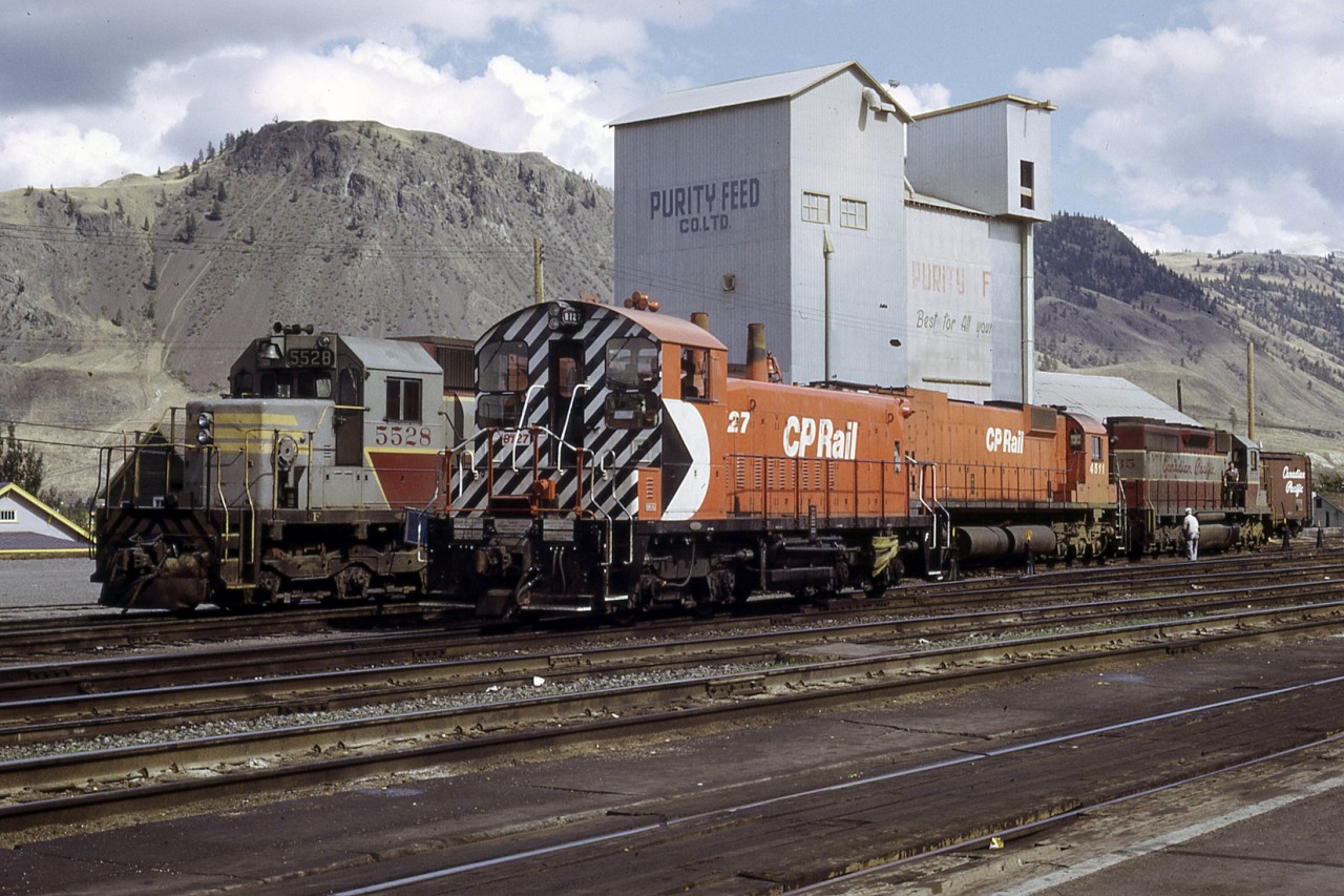 The times are a changing.  The rebranding of CP is well underway.  The action red and multimark are making their way across the system.  Here SD40 5528 along with a sister and an M630 sit in from of the Kamloops icon Purity Feeds.