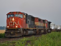 CN X330 heads east out of Sarnia in the early morning haze with this long load of windmill blades.