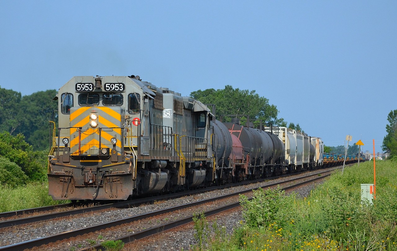 CN 509 led by a pair of grey GTW SD40-3s, heads eastbound out of Sarnia on its way back to London