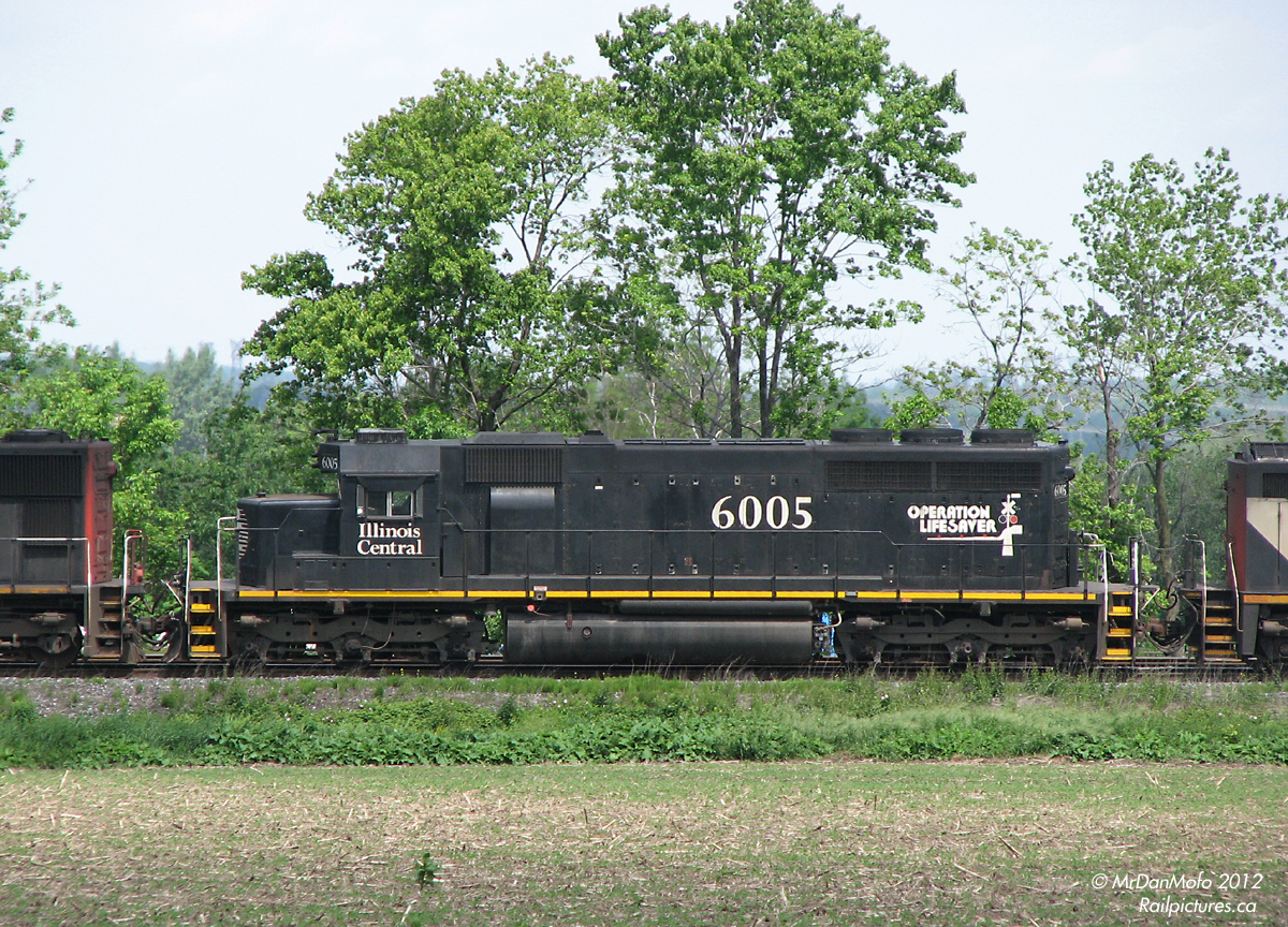 Heading west in the middle of CN #103's power, rebuilt Illinois Central SD40 6005 helps work intermodal traffic westward on the Kingston Sub, about to head up the York sub for the Brampton Intermodal Terminal. In a year or two, she would be retired and eventually cut up for scrap by Allied Services (ASDX).