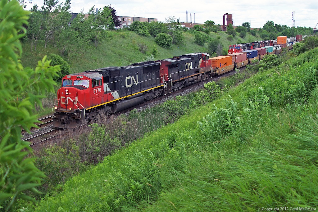A short section of 149 speeds by a slow order westbound in a double west meet in the gully.