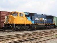 ONT 2102 rests outside in the yard at Englehart Ontario.  It is looking fairly shiny because it has just been returned to service after major wreck repair, following a serious track washout.