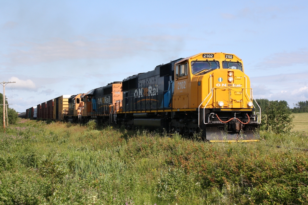 ONR 2102 has been back in service for about a week now and it is seen here leading a southbound freight back to North Bay Ontario.  I am standing on Kerr's road just outside of Englehart.