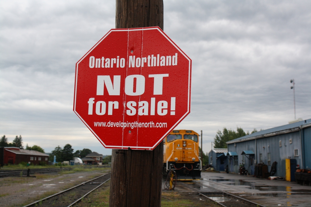Stormy skies are approaching Englehart Ontario on this Saturday morning.  Stormy skies are also on their way to the Ontario Northland Railway.  In March the Ontario government announced that they would be divesting the Ontario Northland.  After the announcement signs like these popped up all over Norhtern Ontario.  To learn more about this please visit the website on the sign.