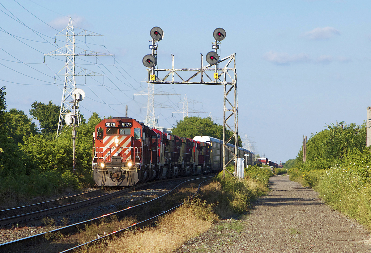 With a heck of a lashup, 423 throttles up under the classic staggered aspects at Bartlett. Lashup was CP 6075, 5790, 8860, 8539 9682, 9376, 8559 with the last five GE's for Vaughan Intermodal Terminal.