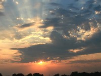 The setting sun emerges from a storm cloud, casting its final rays on the high iron as a clear signal announces the impending arrival of VIA 59 from Ottawa; a fitting end to a busy day trackside with 40 trains passing through in 13 hours.