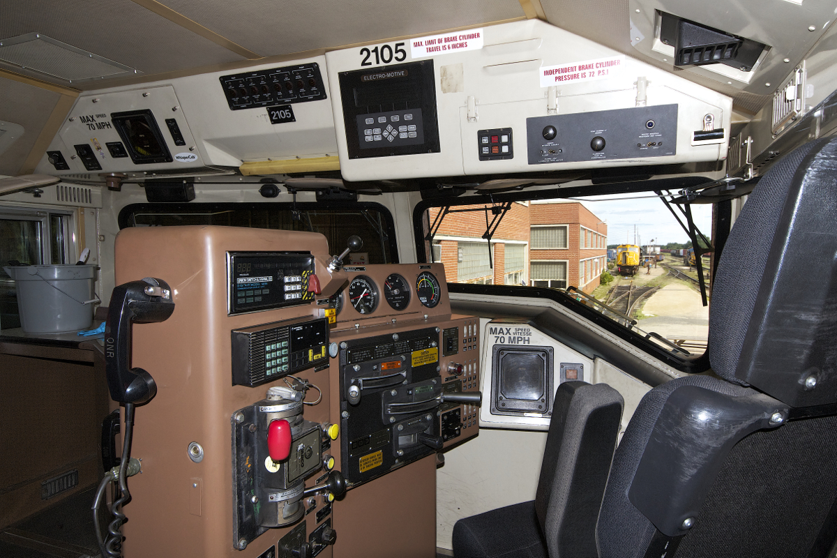 After arriving in North Bay on train 214 earlier in the afternoon, ONR 2105 was sent to the diesel shop for some maintenance and cleaning to be done. This is an interior view of the cab of 2105, in the distance a wrecked sister SD75i and 1604 can be seen in the yard. This photo was taken during a tour of the Diesel Shops with full permission, full PPE, safety glasses and hardhat were worn.