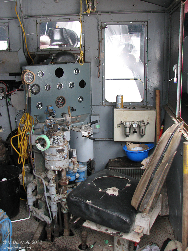 With the fixer-upper interior showing off its ancestory as a well-used quarry critter, TRHC 1 idles outside the roundhouse while moving equipment around. Having come a long way since being built for Pinecrest quarry in the early 1950's, at the time of this photo the unit was only recently acquired from the YDHR. Capable of operation, the Toronto Railway Heritage Association has already begun work in it including a new paint job and a new bell (later would follow more extensive work such as an engine rebuild). The CLC-Whitcomb 50-tonner was acquired by the museum because of its local (quarry) ancestory, and that it was able to move and fit with CNR 6213 on the John St turntable, among other reasons.