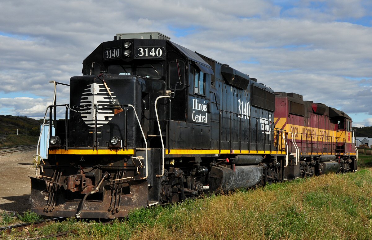 Far away from home, former Illonois Central 3140 and Wisconsin Central 2003 are standing in Taylor/BC