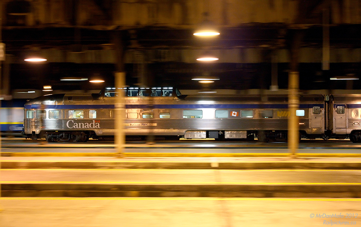 Dodging the pillars of the train shed, VIA's Kokanee Park brings up the tail end of the Canadian as VIA #1 makes its departure from Toronto on its transcontinental trip. A few passengers who haven't retired to their sleeping quarters have climbed up into Kokanee Parks' domed section for the first leg of the journey, unfortunately under darkness.