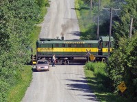 A volunteer protects the crossing as The York Durham Heritage Railway excursion train rolls through the hills of Uxbridge Ontario.