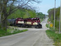 OSR struggling to warm the journals as she shoves numerous empties back, uphill and around a curve, into the Cami Plant.