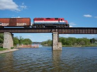 RLK 4057 is pulling eleven cars across the Grand River at Caledonia.  At this point they are about a third of a way across the bridge.  With the impending sale of Rail America, in the next few years we may see a photo of an Orange and Black GP40-2 crossing the bridge.
