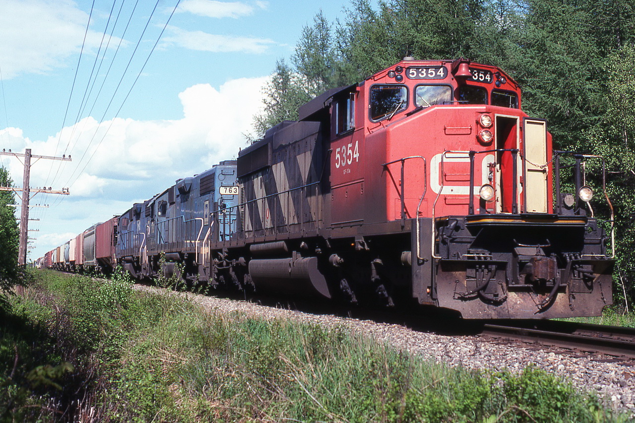 CN 391 approaching the curve 1 mile east of the town with 2 loaned GM used SDs.