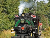 As the Portage Flyer approaches the Forbes Hill Drive crossing Brakeman Alex prepares to hop off a nd throw the switch after the train crosses it to allow the locomotive to be run around for another trip after taking a spin on the turntable.