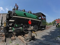 Number 2 eases over the switch points for the crossover from Track 1 to Track 2 after uncoupling from its train - which is visible by the Rotary Village Station in the background - on its way to the turntable to be spun around. Then it will run around the coahes and hook up to wait for the next run. Also visible in this shot are the saddle tank for Number 1 sitting forlornly in the grass on the right hand side waiting for the day it will once again be mounted over the boiler and filled with water to make its own runs up and down the line. Number 1 has a couple of cracks in the boiler that need to be repaired before it can be steamed up, and also is in need of an air puimp (under construction at present) and conversion from coal to oil-firing for safety and economic reasons among others. We're hoping to get her at least close to completion next year, if given the go-ahead by the town.  