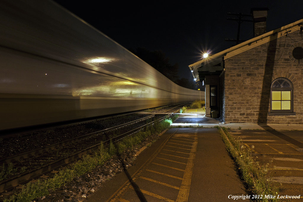 Slithering through the night, CN 120 slips past the 1850's era Grand Trunk station in Port Hope, Ontario. 0124hrs.