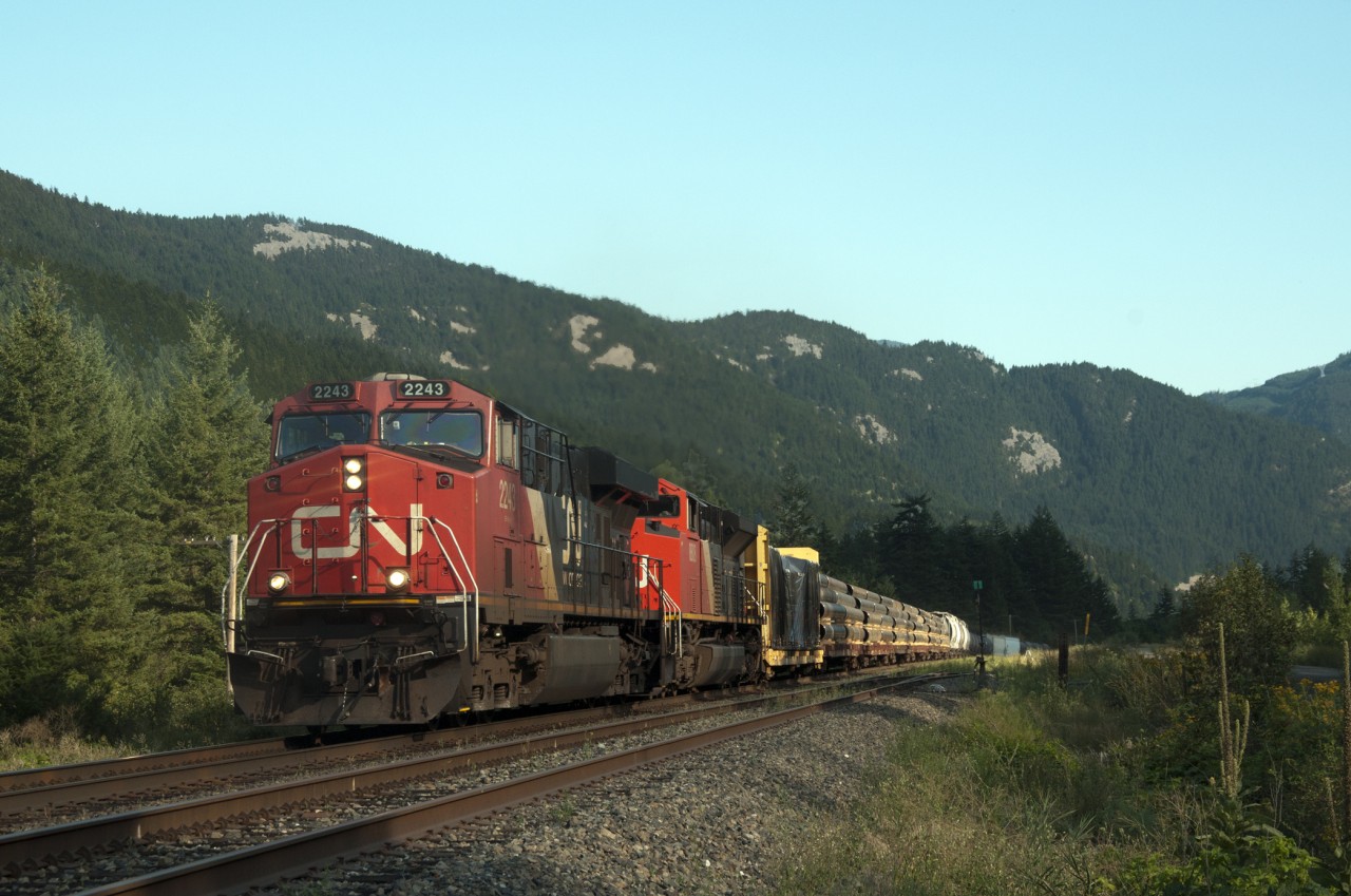 The sun is putting out its last rays of the day as CN 2243 leads mixed freight including dimensional loads eastbound on Canadian Pacific rails at Chaumox.  For any fellow fans who might find this spot, look back in the trees where one will find an old, nearly forgotten, grave yard. It latest markers are from the early 1940's. There is no town, no longer any residents save for the occasional bear or deer that abound in the area.
