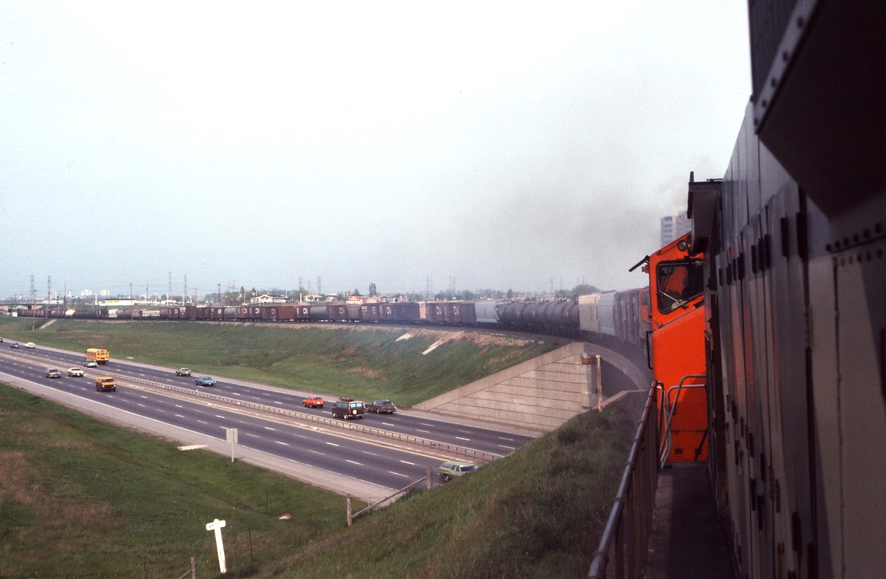CN 397 begins its assault on the ruling grade of the York Sub with westbound tonnage, as seen from the cab of a CN MLW.   Quite alot has changed since 1979, the 401 has been expanded and the GO sub now crosses under the York sub at this location - not to mention the motive power we're riding in!
