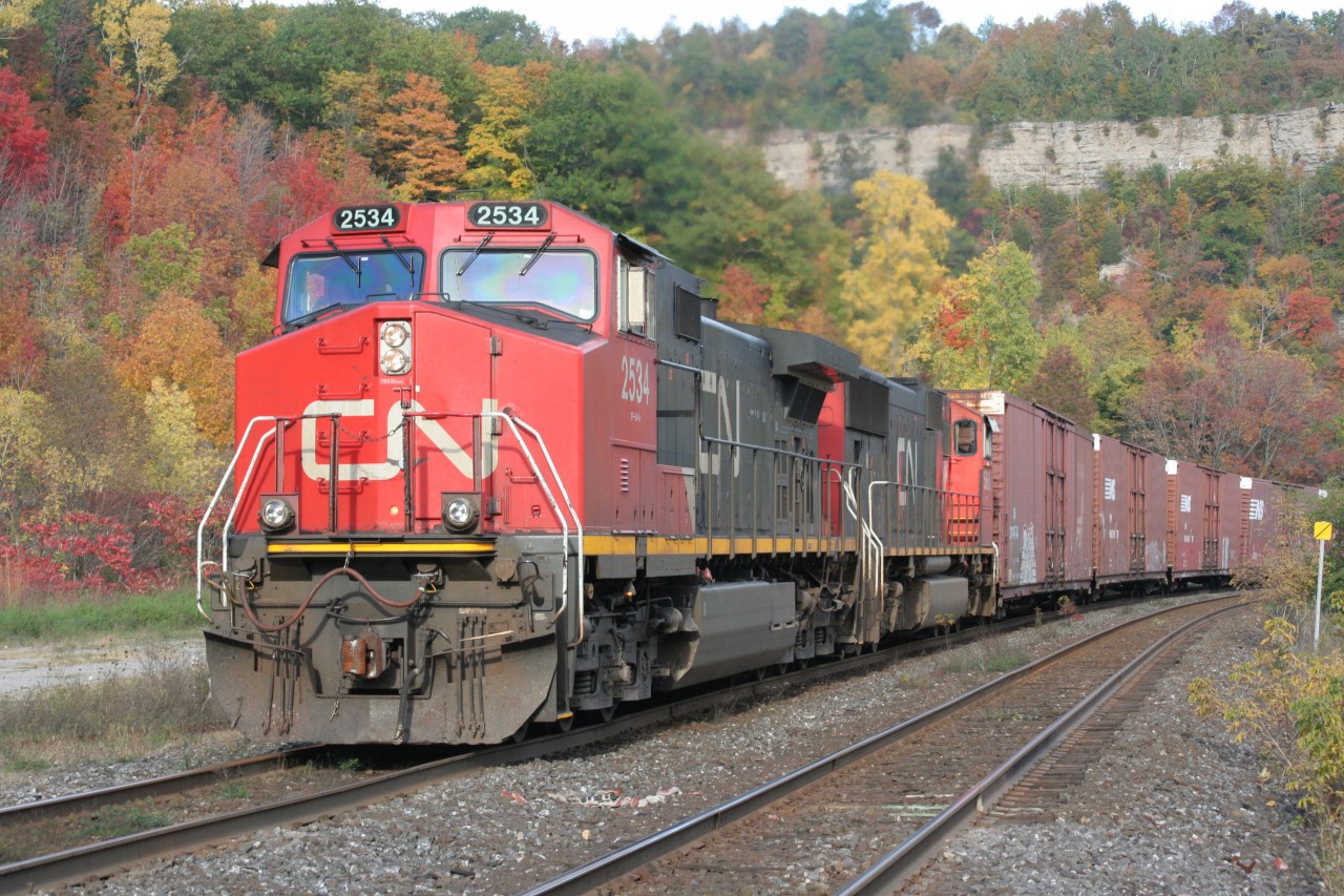 A westbound CN freight climbs the escarpment at Dundas with fall colours draping the limestone and dolostone of the Niagara Escarpment.