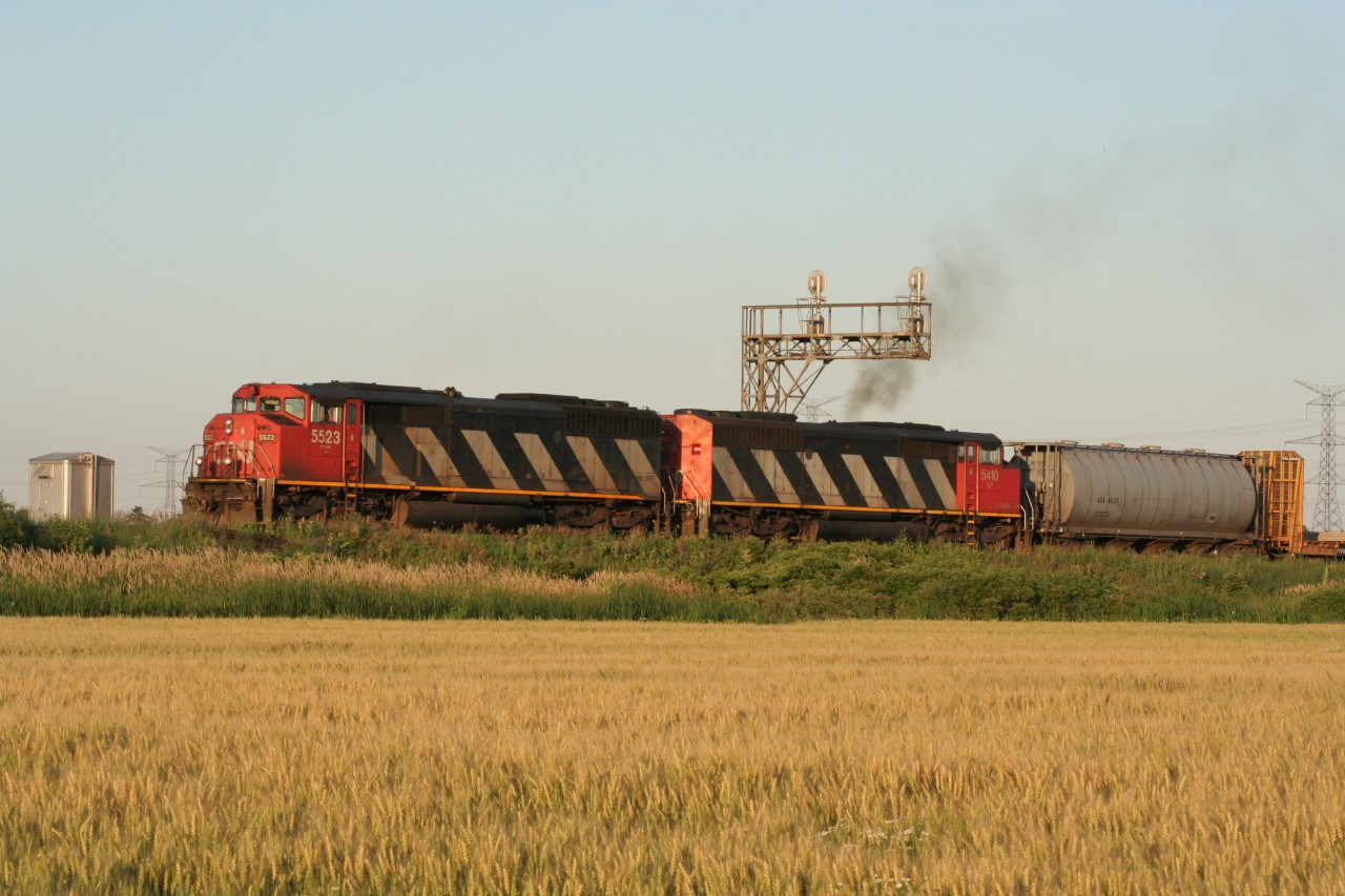 Two CN zebras lead an eastbound manifest towards MacMillan Yard on a beautiful summer evening.