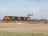 CN 148 led by engine number 5648 causes birds to scatter as it ducks under the signals at CN Mansewood.
