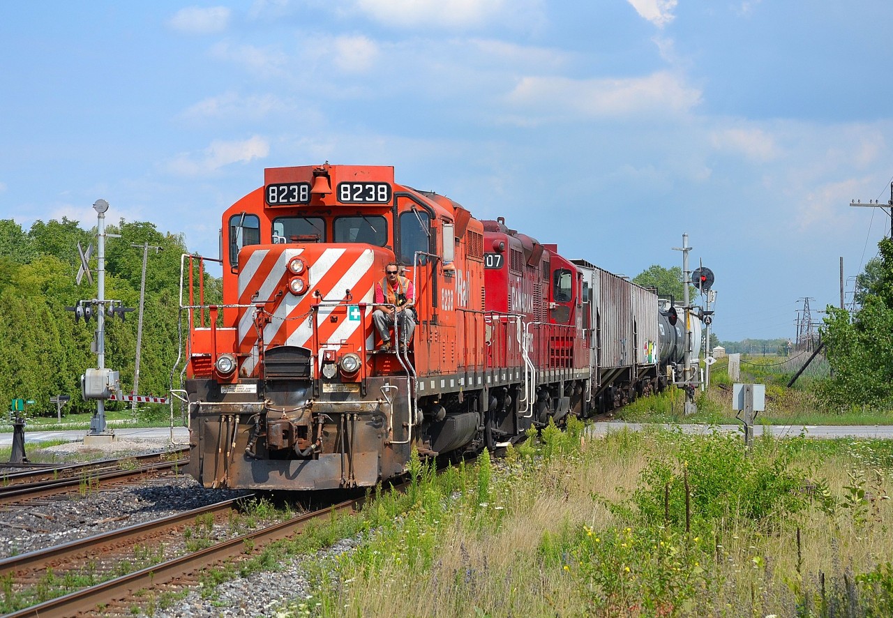 CP T76 slowly proceeds westbound thru Tilbury as an oncoming eastbound is going into the siding