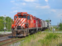 CP T76 slowly proceeds westbound thru Tilbury as an oncoming eastbound is going into the siding