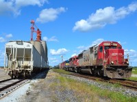 CP 641 with a great all EMD lashup, heads westbound as it passes the grain elevator at Glencoe.