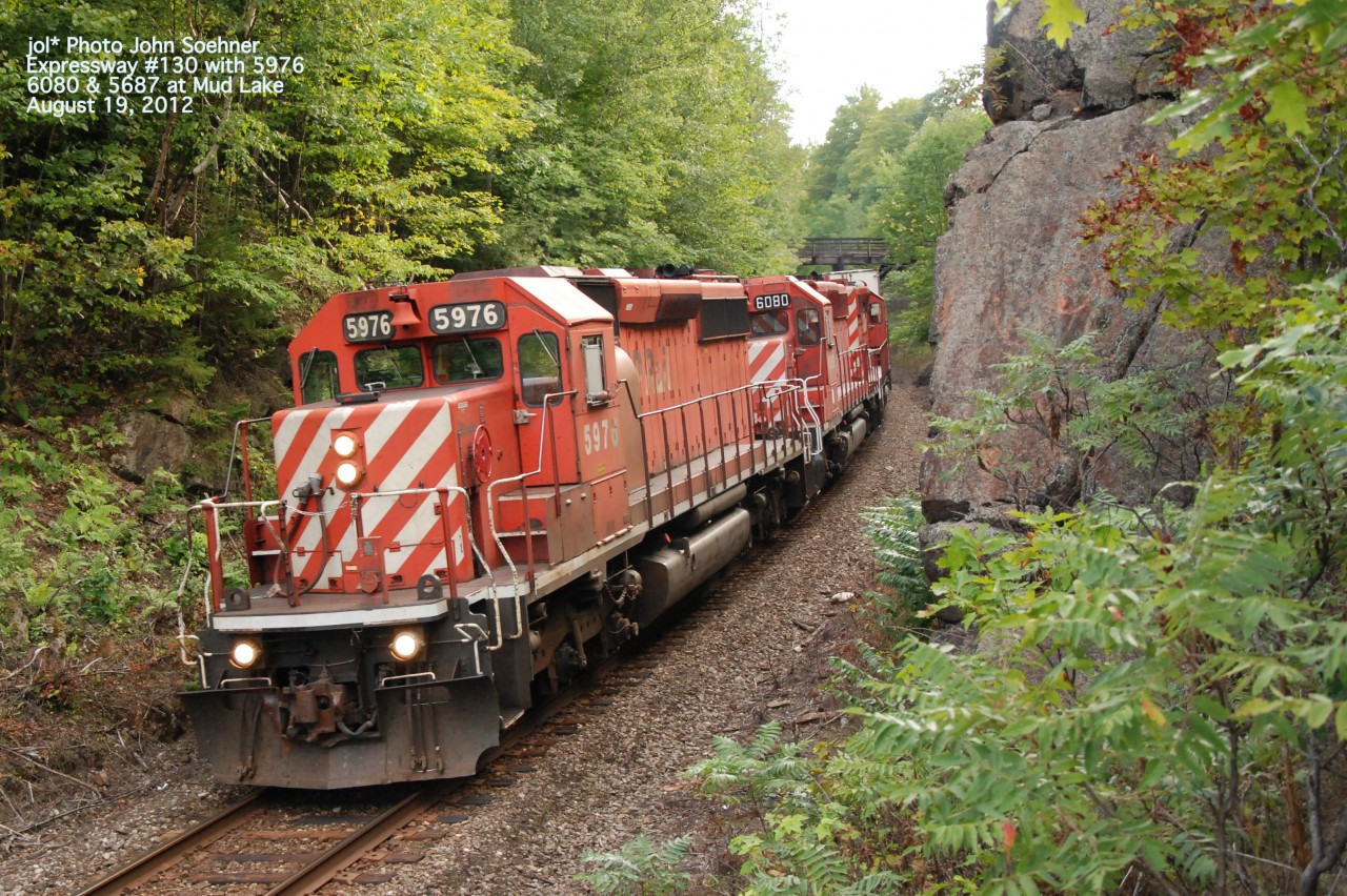Expressway #130 in the cut, on the curve west of the Mud Lake Trestle; the Feldspar wood rood bridge over Lanark County Rd, 36 in the background.