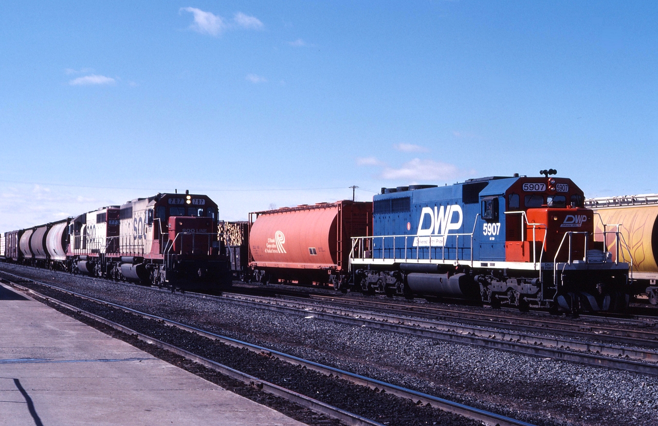 DWP train #812 led by DWP 5907 and CN train #406 with a pair of SOO run thru units are about to interchange cars at Fort Frances