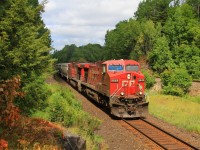 A southbound CP freight led by unit 9649 roars out of a rock cut as it approaches Rosseau Road