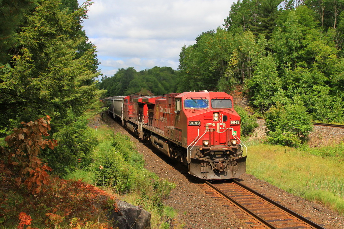 A southbound CP freight led by unit 9649 roars out of a rock cut as it approaches Rosseau Road