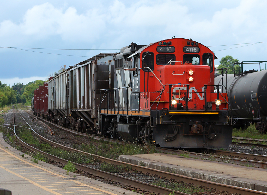 CN 4116 arrives back into Brantford where the crew will end their shift and begin their weekend. The engineer is waving to a little boy how is also watching all the action.
