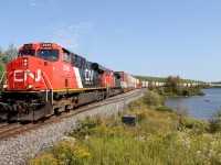 I have been wanting this shot of a stack train all summer, and finally it worked out with a late 115. Here train Q11531 28 rolls along the shores of Cass Lake at Arms Pit (former spur for the pit mid center, complete with a heavyweight coach) with 92 platforms for Calgary Intermodal Terminal. To boot, we have a spotless GEVO on the point.