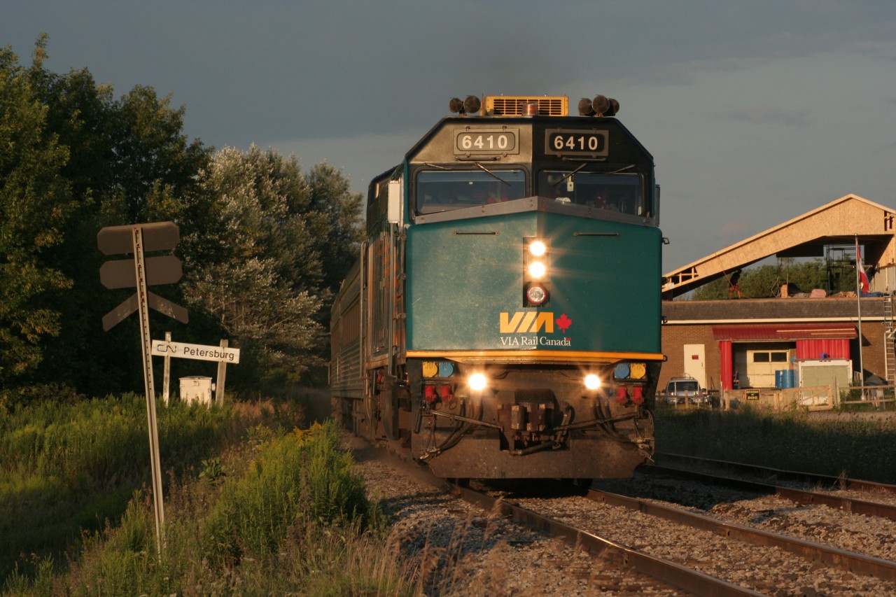 VIA 087, with newly-repainted 6410 on the point, screams past the CN Petersburg sign, at Petersburg siding on the GEXR Guelph Sub, bound for London.