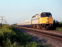 VIA 27 costs slowly on the siding for its brother VIA 26 passing soon.