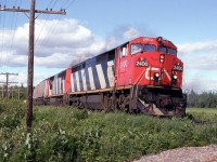 CN 231 rounds the curve and begins the 1 mile downgrade with a long train and 2 almost new GEs.