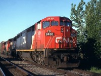 CN 305 coast slowly downgrade on the siding for a meet.