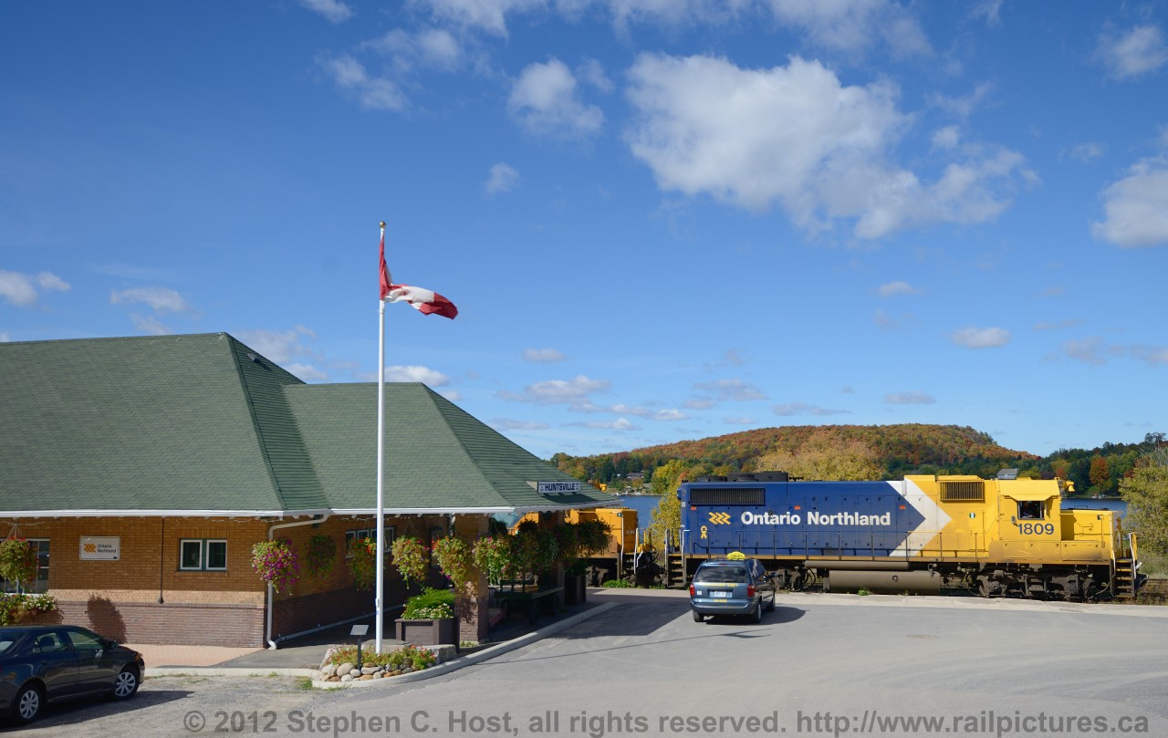 Ontario Northland train 697, the "Northlander" makes its second to last stop, ever, at Huntsville Ontario where a lone taxi waits for a potential passenger. No one took the taxi, 6 mennonites and a father and son got off the train and pursued to walk downtown. Consist was the only unit in this scheme - 1809, 1800, APU 202, 4 coaches and snack/lounge car..